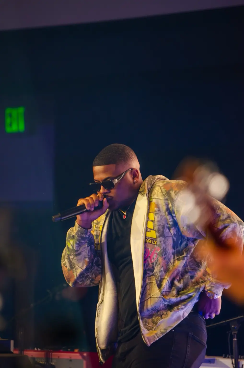 Eli in the Mix commanding the stage with a microphone
